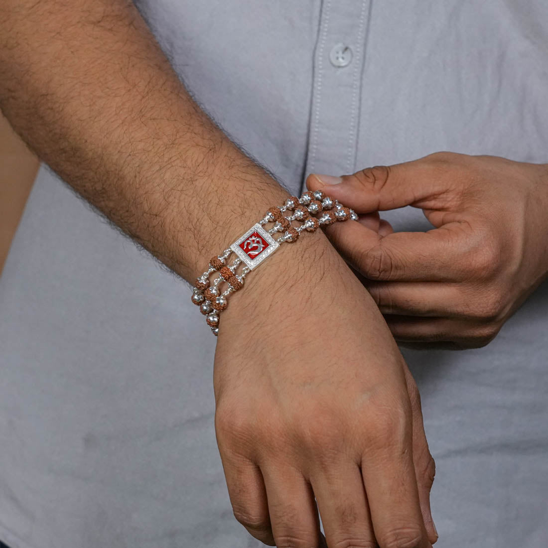 Rudraksha Silver Om in Red Triple Line Bracelet