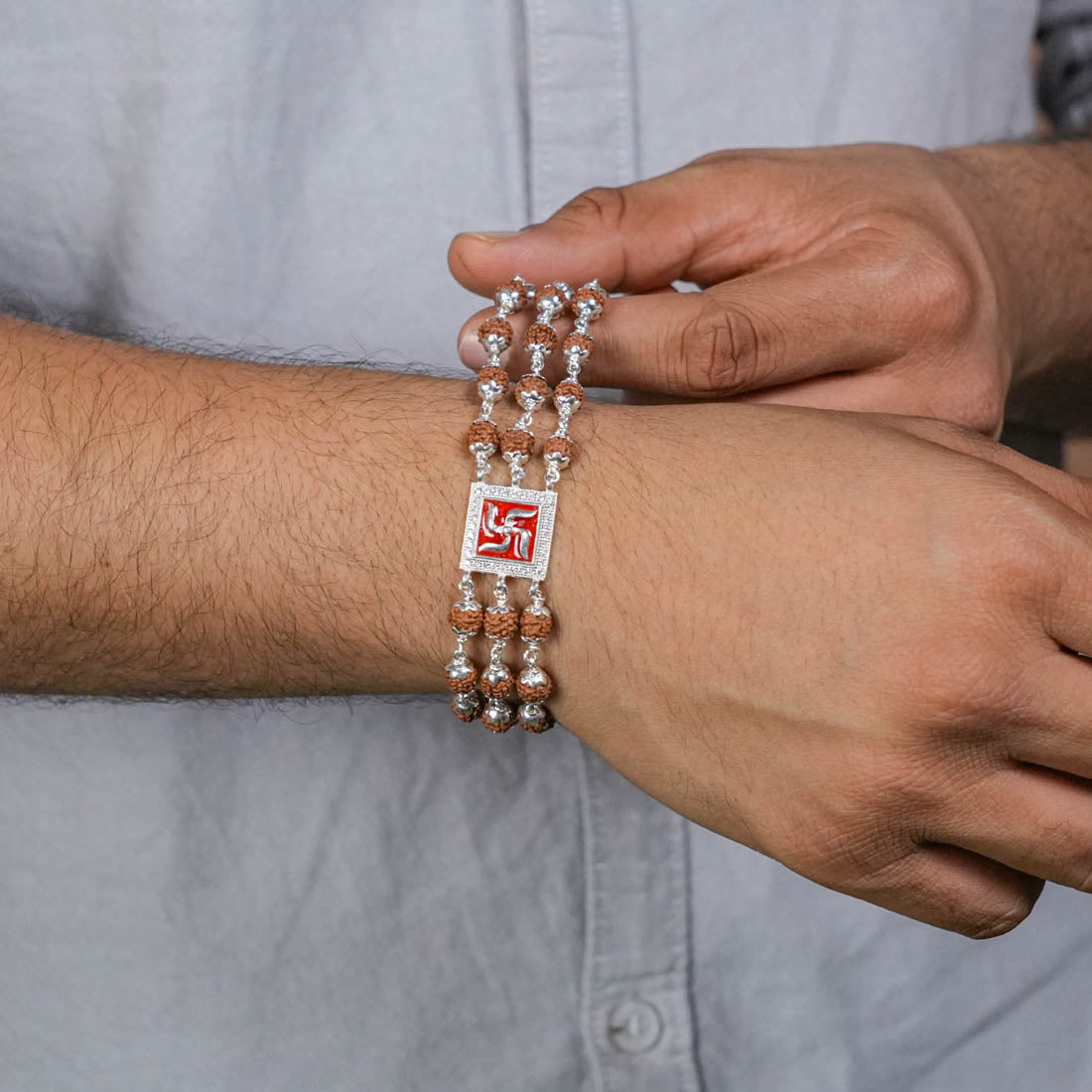 Authentic Rudraksha Silver Swastik in Red Triple Line Bracelet