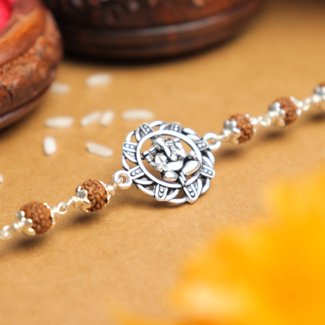 Original Silver Rakhi with Ganesh in a Designer Circular Sphere and Single Line Rudraksha